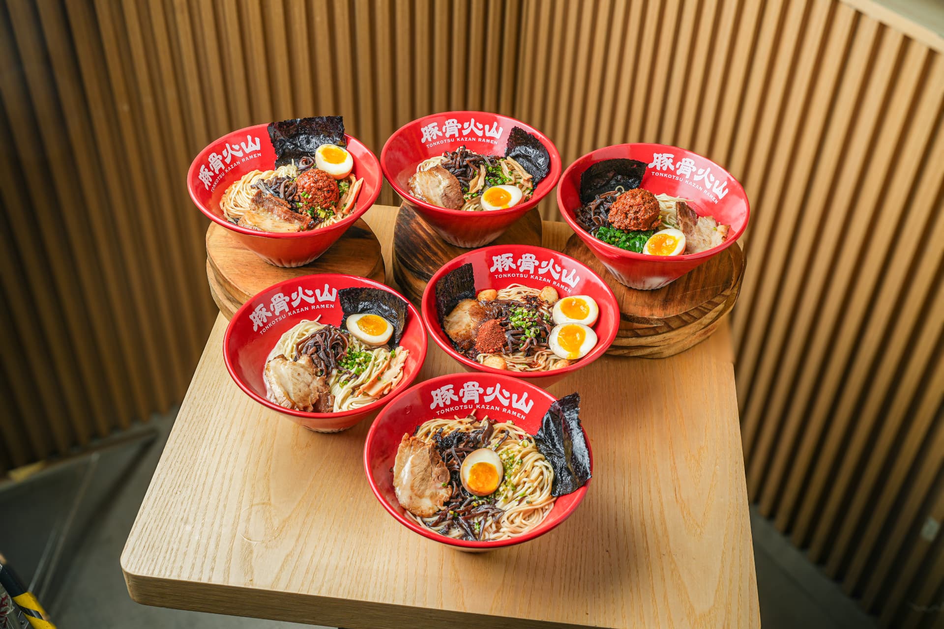 Six red Kazan ramen bowls photographed from above